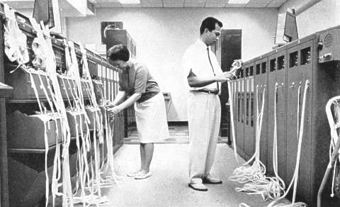 Paper tape relay operation at US FAA's Honolulu flight service station in 1964 showing a large number of punch tapes