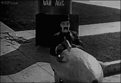 Silent movie clip of man in a cart catching a ride with a car passing by using a giant magnet